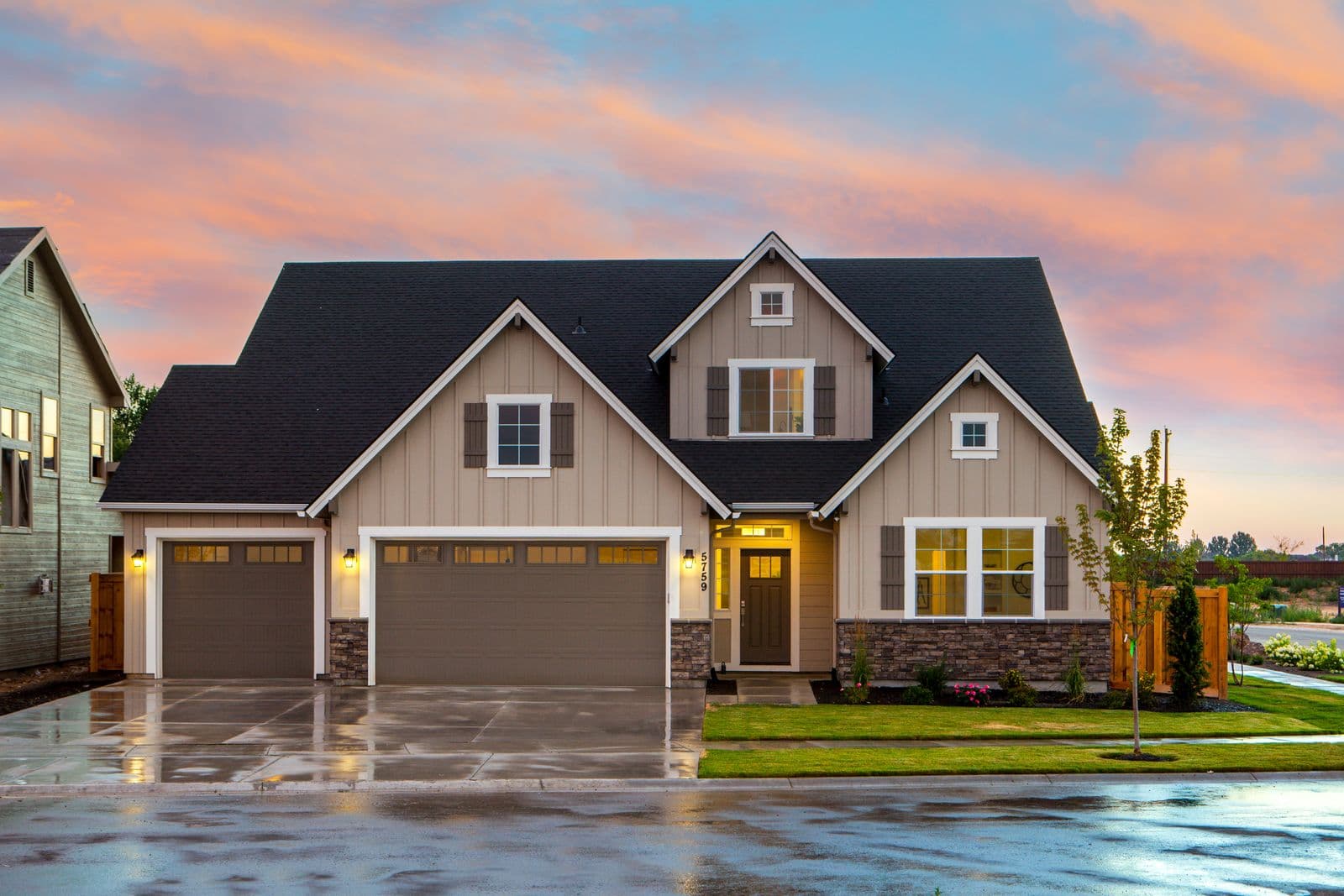 A two storey family home under a colourful evening sky