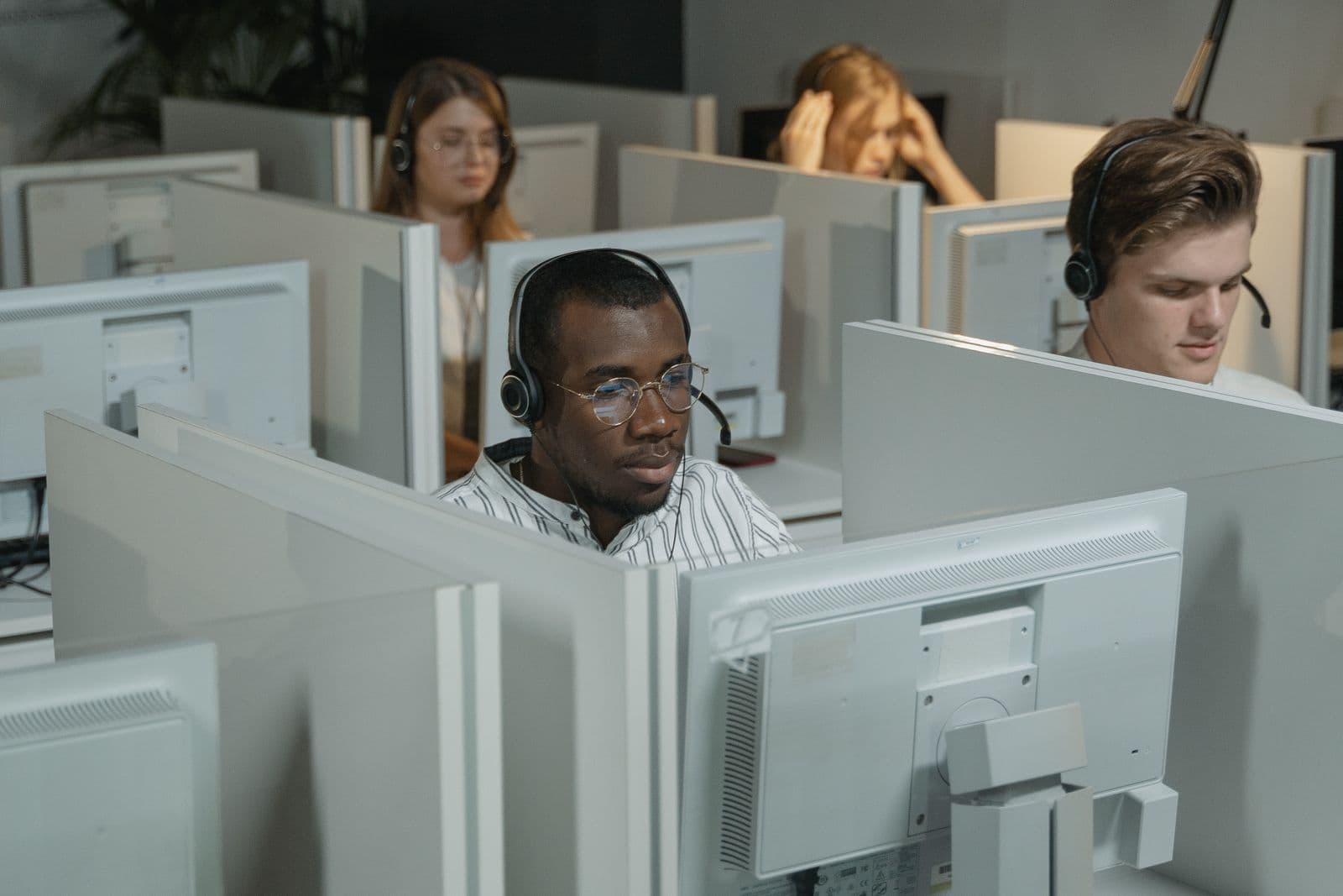 Cold calling agents wearing headsets on a live calling floor